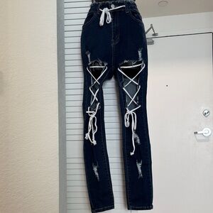 Stylish Distressed Blue Jeans with Lace-Up Detail